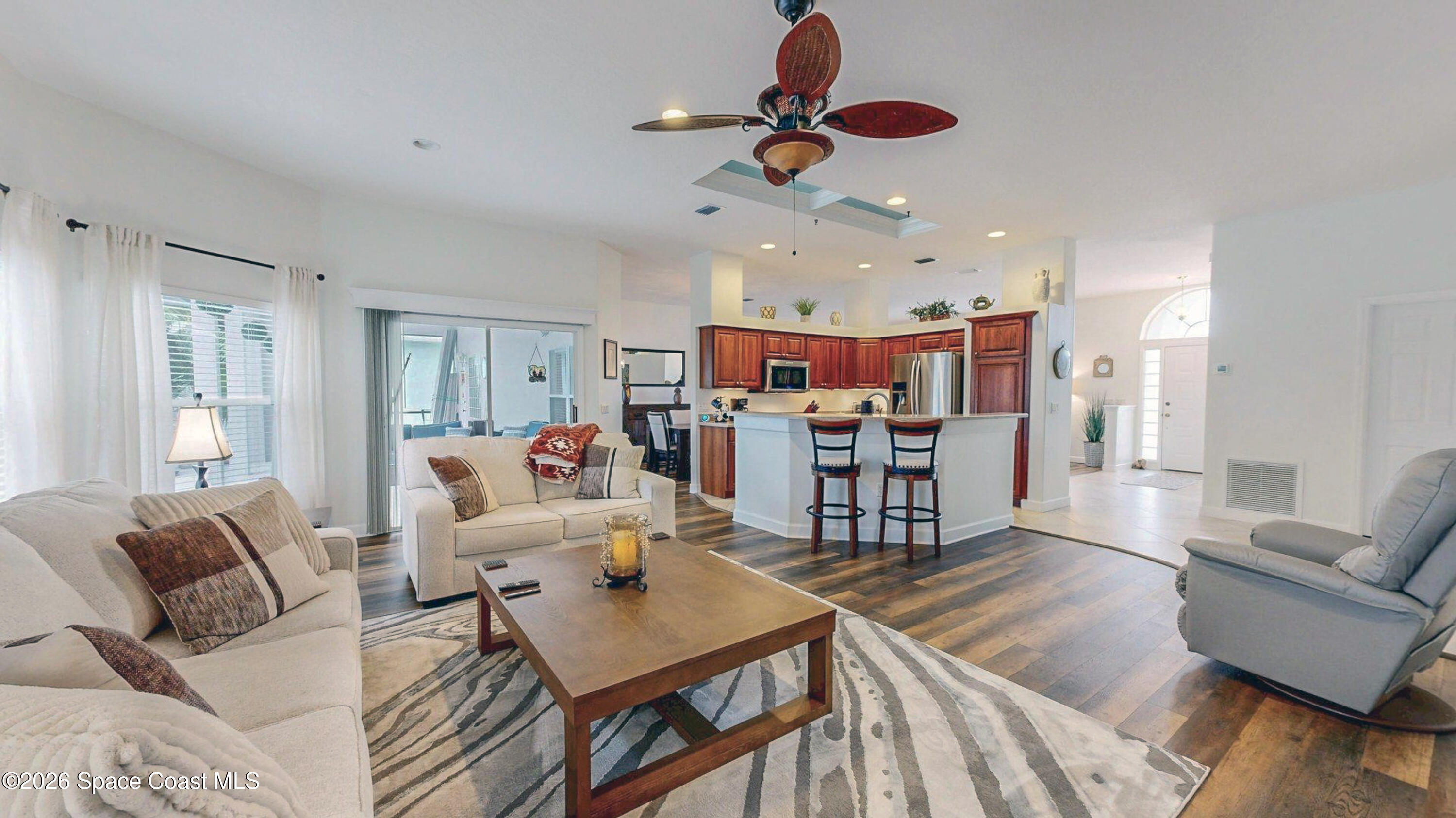 786 Conestee Drive Melbourne, FL 32904 - Photo 2 of 38 a living room with furniture kitchen view and a chandelier