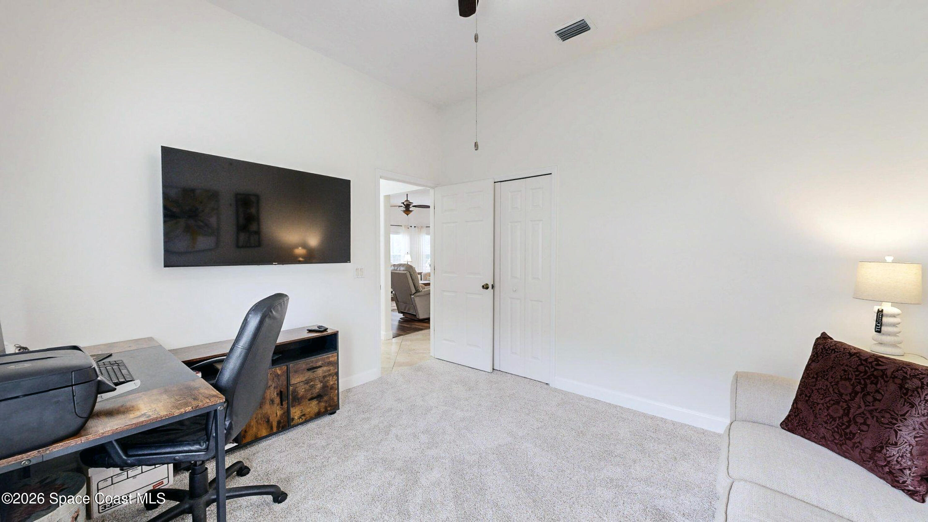 786 Conestee Drive Melbourne, FL 32904 - Photo 26 of 38 a livingroom with workspace and a window