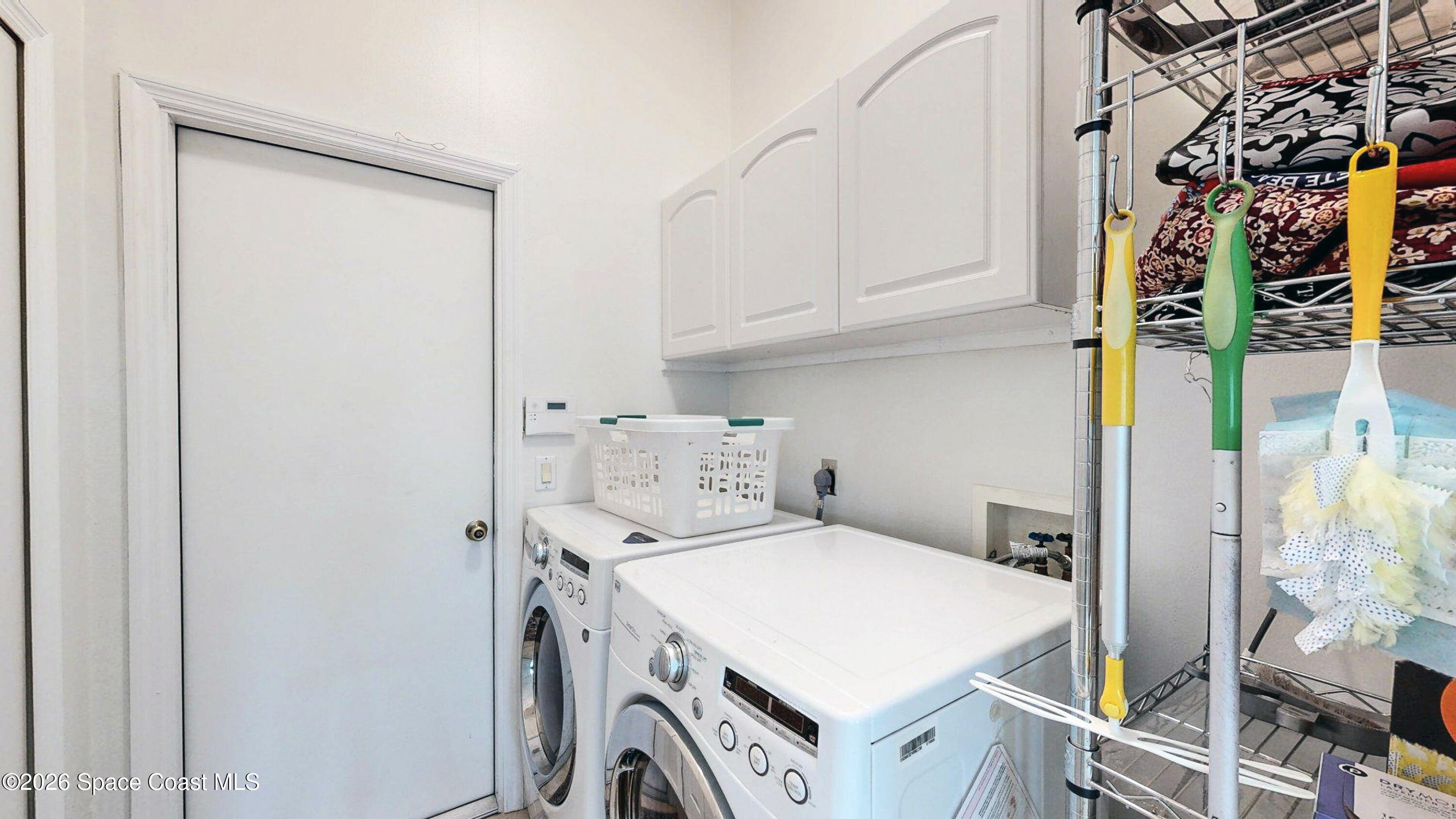 786 Conestee Drive Melbourne, FL 32904 - Photo 27 of 38 a utility room with dryer and washer