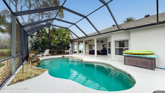 a swimming pool with outdoor seating yard and furniture