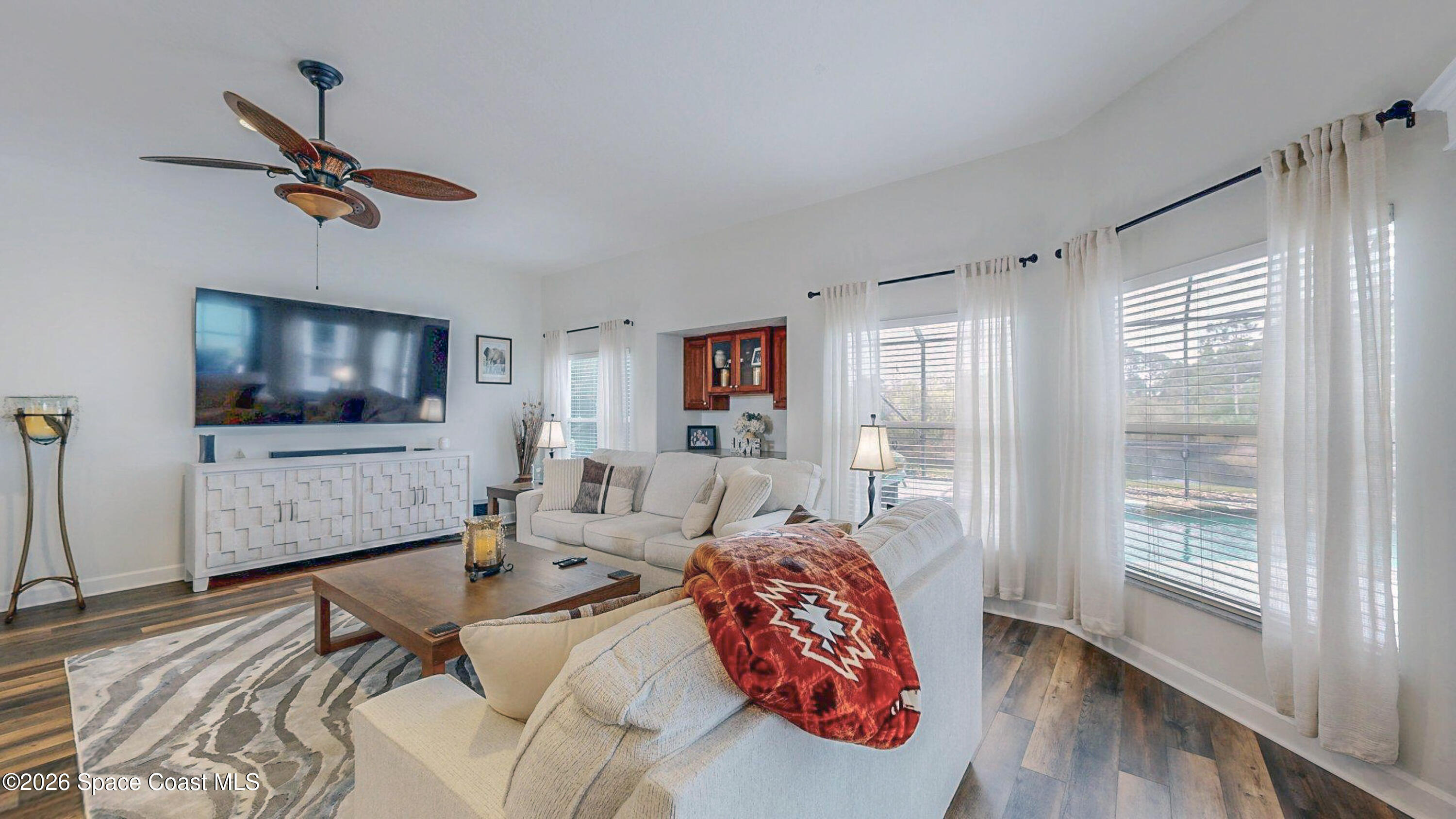 786 Conestee Drive Melbourne, FL 32904 - Photo 4 of 38 a bedroom with furniture and a flat screen tv