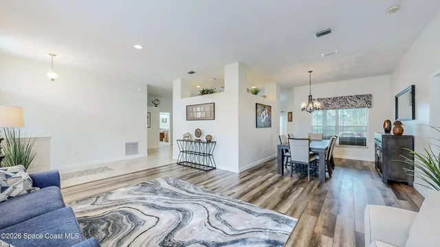 a bedroom with furniture and a wooden floor