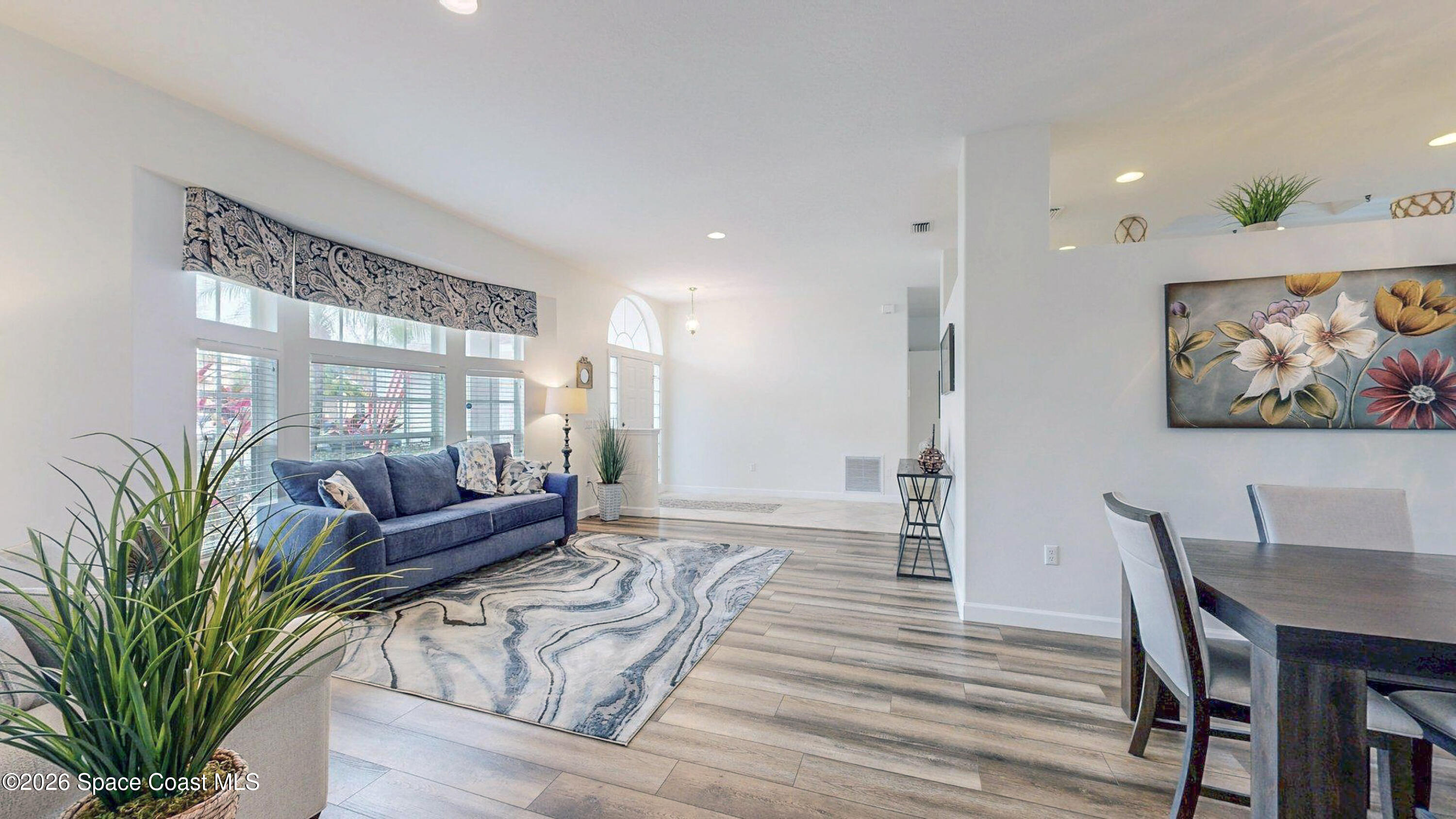 786 Conestee Drive Melbourne, FL 32904 - Photo 8 of 38 a living room with furniture a wooden floor and a potted plant