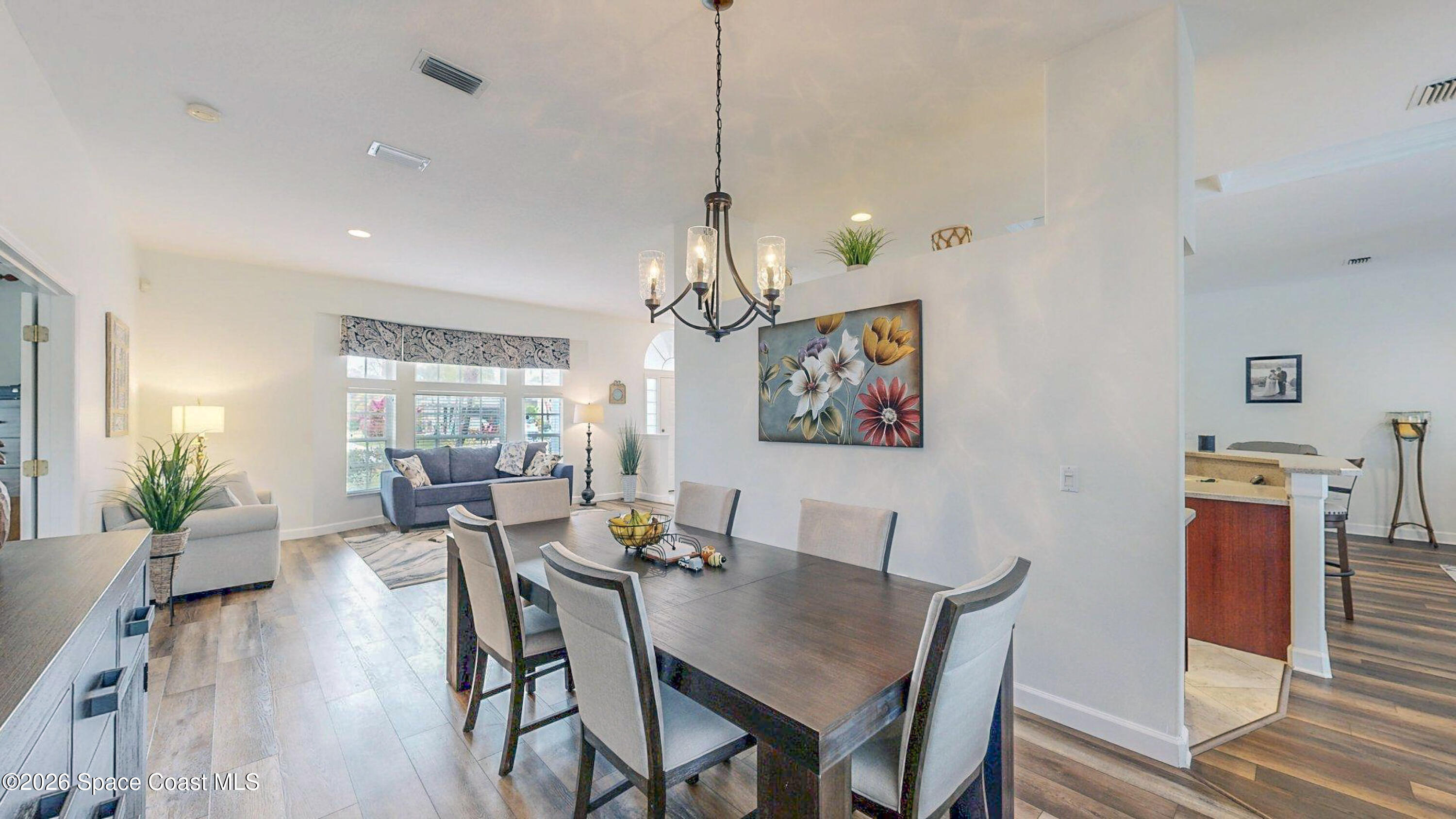 786 Conestee Drive Melbourne, FL 32904 - Photo 9 of 38 a view of a dining room with furniture window and wooden floor