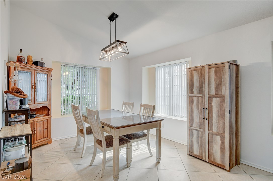 337 Washoe Way Henderson, NV 89074 - Photo 5 of 20 Dining room featuring light tile patterned floors, vaulted ceiling, and suspended lighting