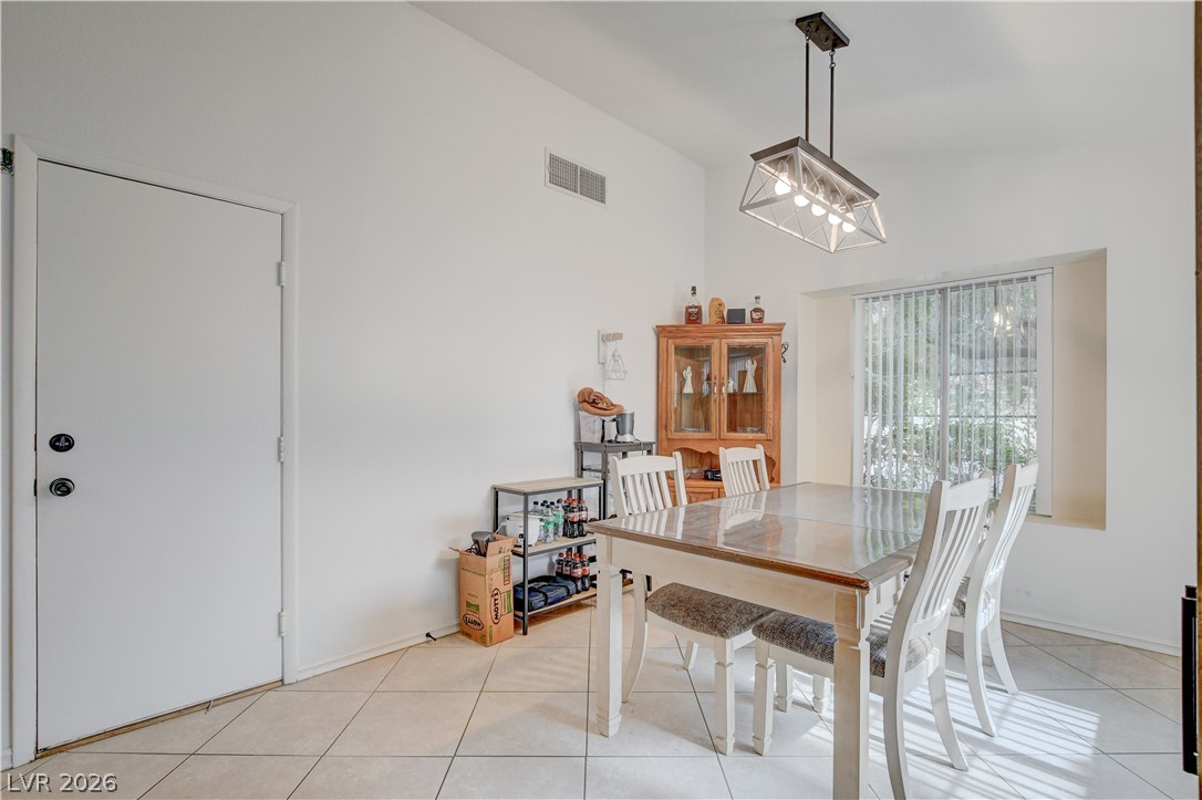 337 Washoe Way Henderson, NV 89074 - Photo 6 of 20 Dining area with light tile patterned flooring and hanging lights