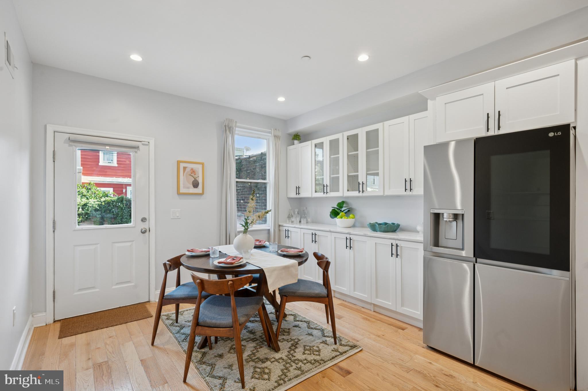 3263 Chatham Street Philadelphia, PA 19134 - Photo 11 of 46 a kitchen with a refrigerator a table and chairs in it