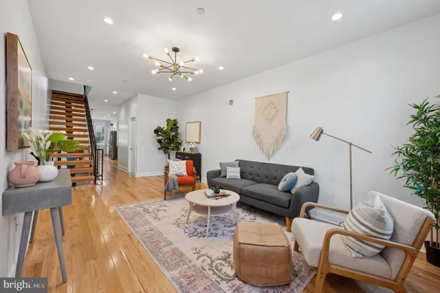 a living room with furniture and a chandelier