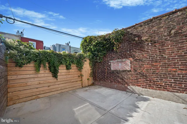a view of a patio with table and chairs and potted plants