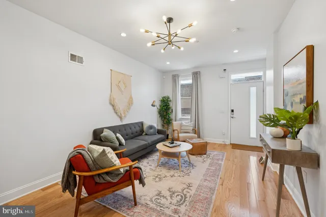 a living room with furniture and wooden floor