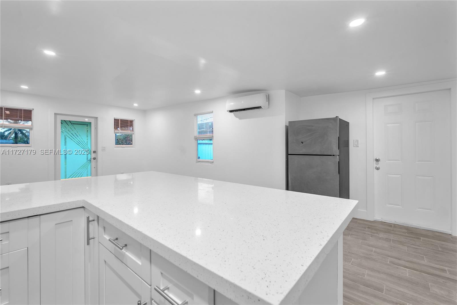 2372 Northwest 34th Street Miami, FL 33142 - Photo 13 of 50 a kitchen with a white table chairs and a refrigerator