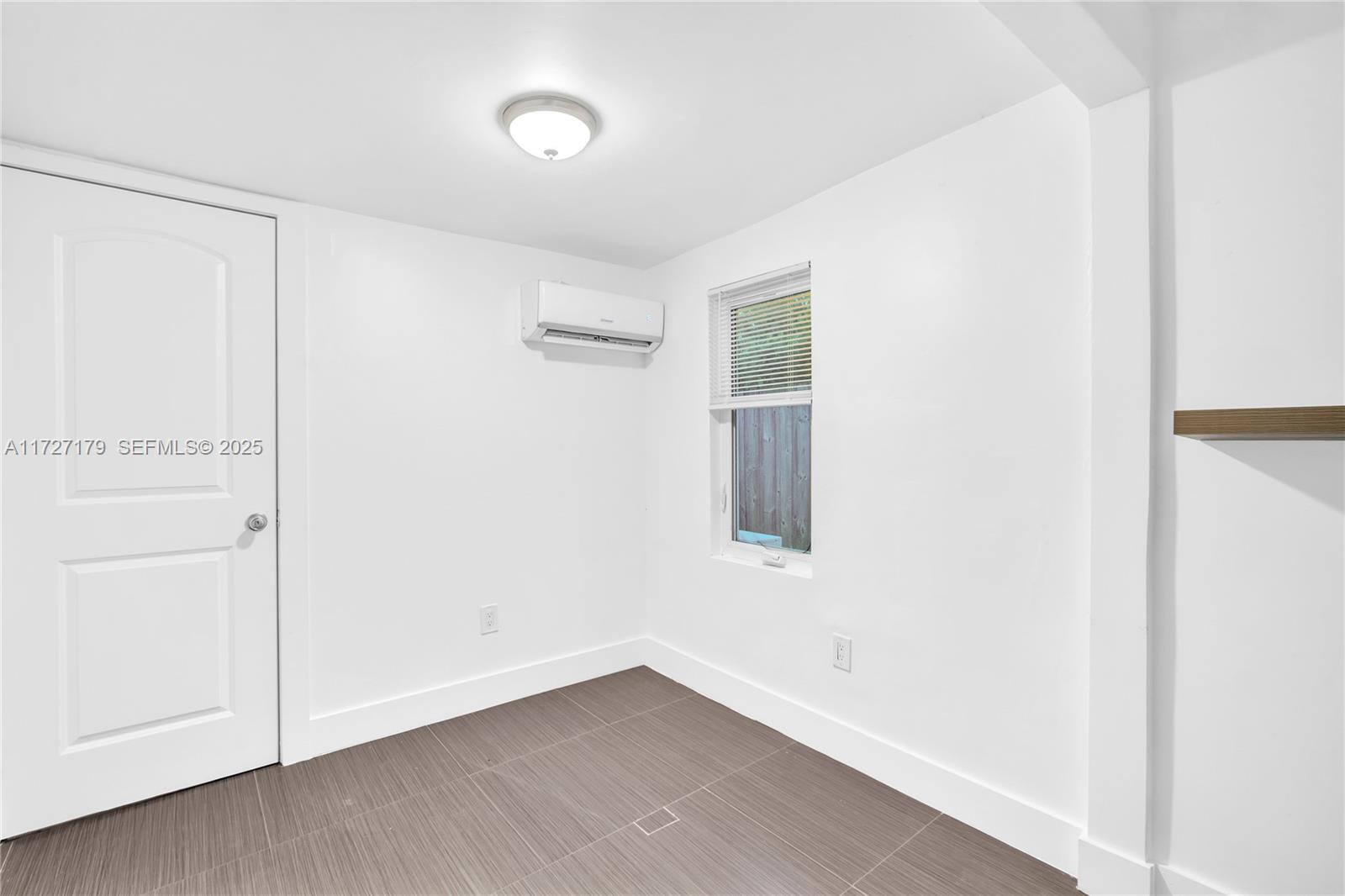 2372 Northwest 34th Street Miami, FL 33142 - Photo 19 of 50 a view of an empty room with a window
