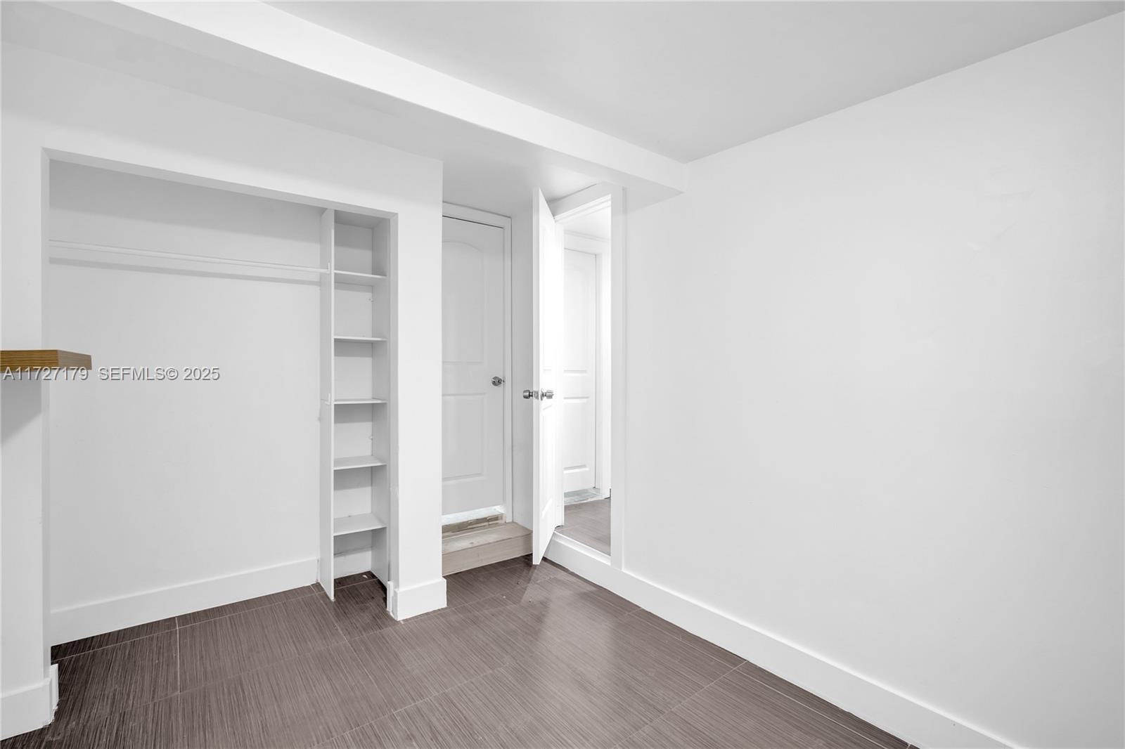 2372 Northwest 34th Street Miami, FL 33142 - Photo 20 of 50 an empty room with walk in closet and wooden floor