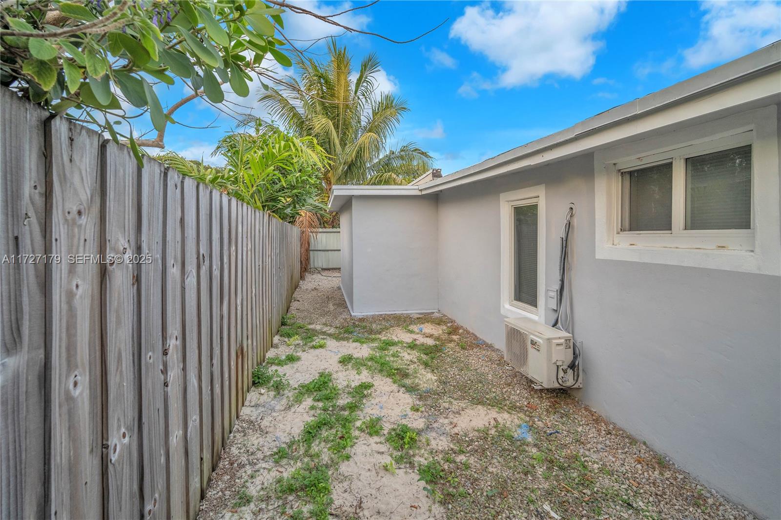 2372 Northwest 34th Street Miami, FL 33142 - Photo 49 of 50 a backyard of a house with plants and wooden fence