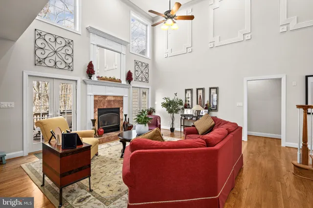 a kitchen with stainless steel appliances granite countertop a refrigerator a stove top oven and a dining table with wooden floor