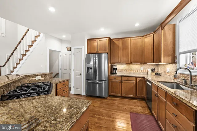 a bedroom with a bed couches and a flat tv screen on dresser