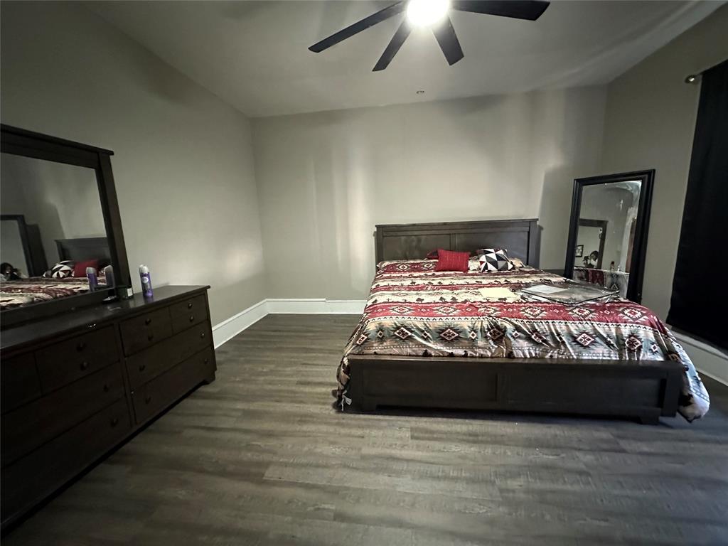 1824 Lyle Avenue Waco, TX 76708 - Photo 9 of 13 Bedroom featuring dark wood finished floors and a ceiling fan