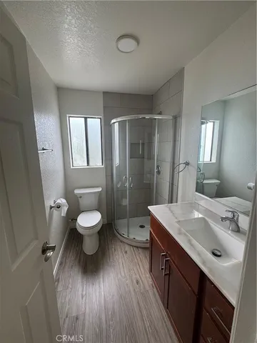a bathroom with a sink toilet a mirror and shower