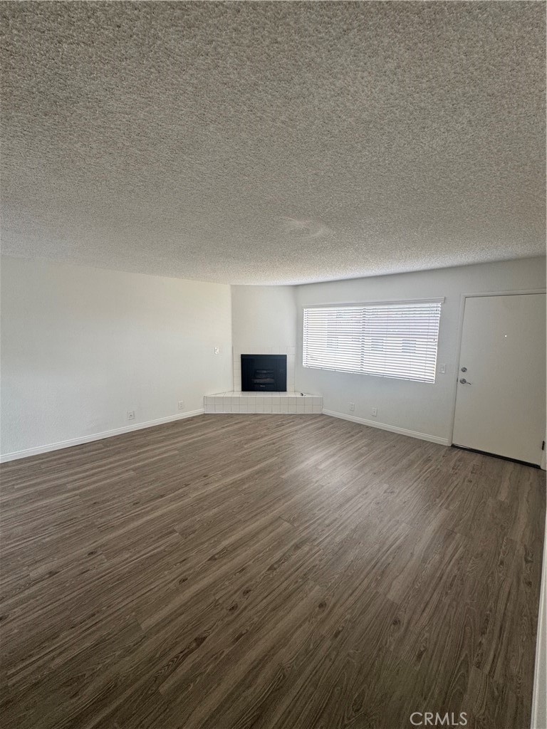 216 Sheldon Street, Unit 1 El Segundo, CA 90245 - Photo 7 of 16 an empty room with wooden floor and windows