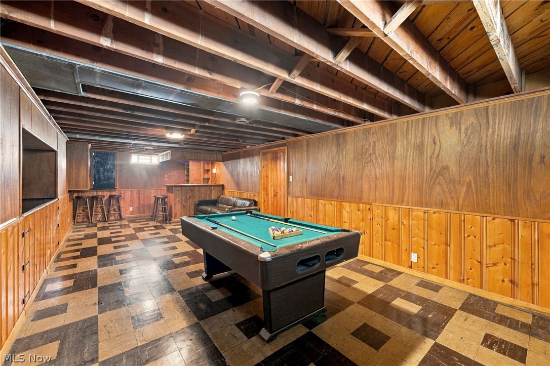1434 Sunset Road Mayfield Heights, OH 44124 - Photo 30 of 36 Wood paneling and exposed ceiling beams with a built-in bar area, checkerboard floor finish, and recessed lighting