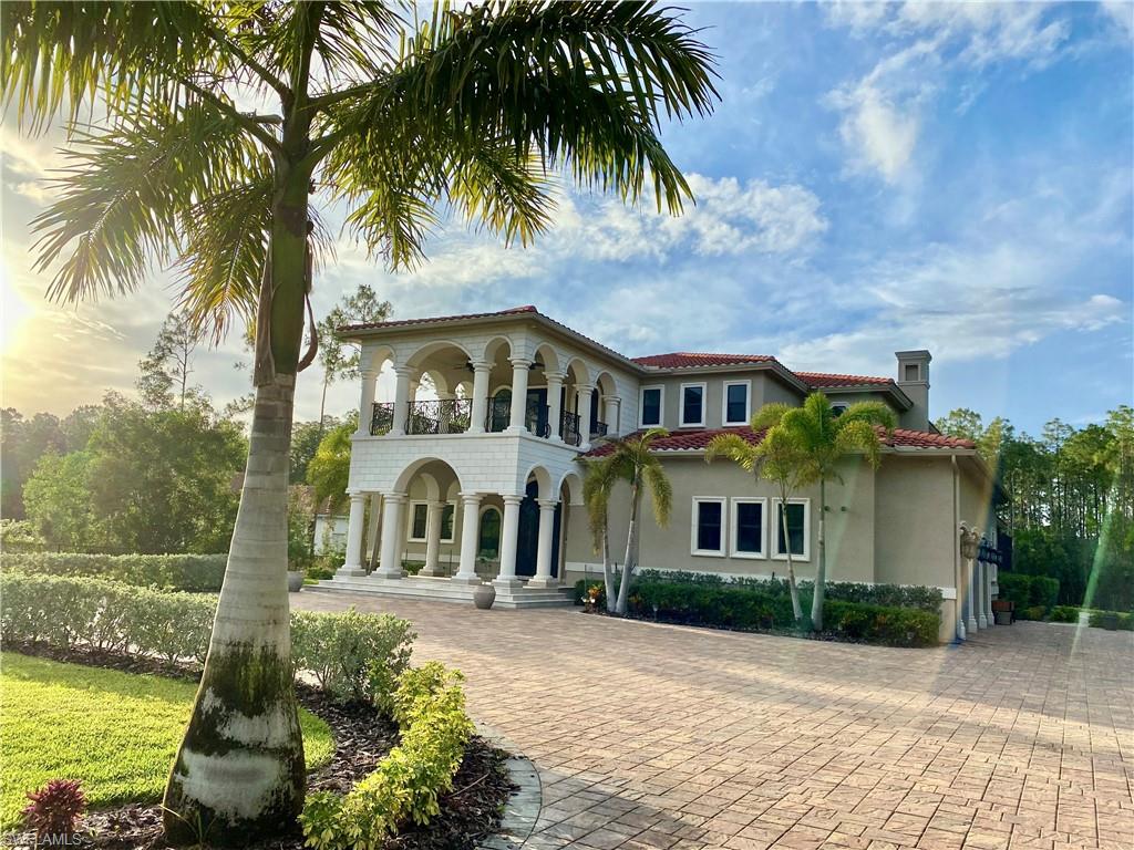 Undisclosed Address Naples, FL 34109 - Photo 1 of 33 a front view of a house with a garden