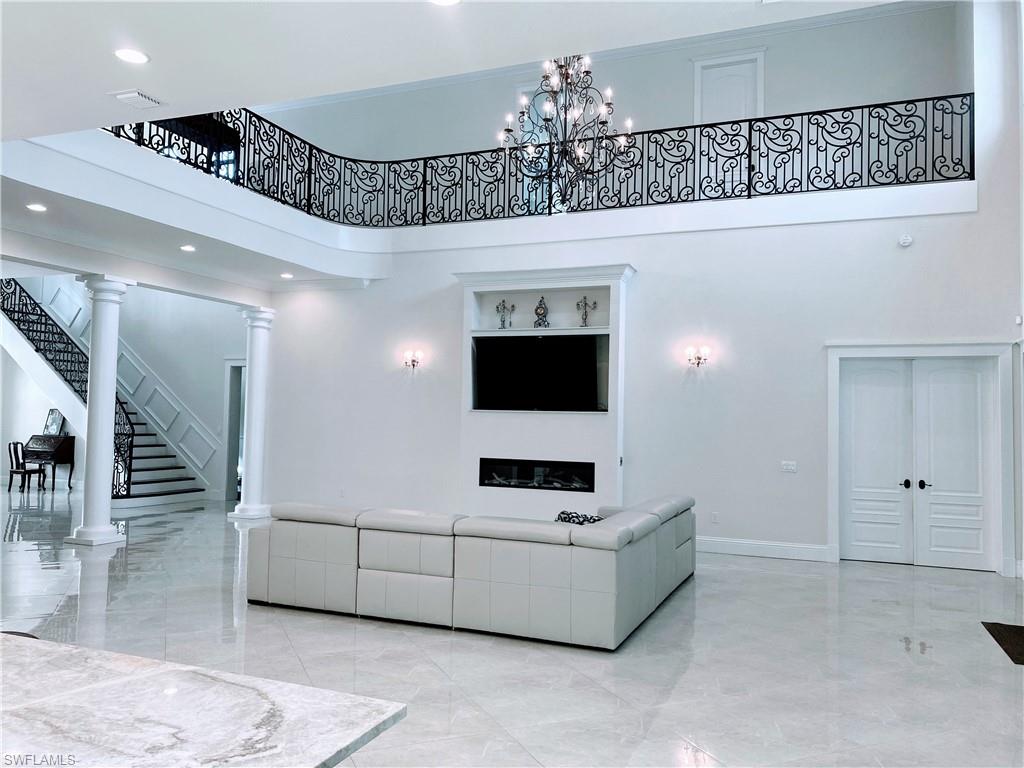Undisclosed Address Naples, FL 34109 - Photo 12 of 33 a living room with furniture and a chandelier