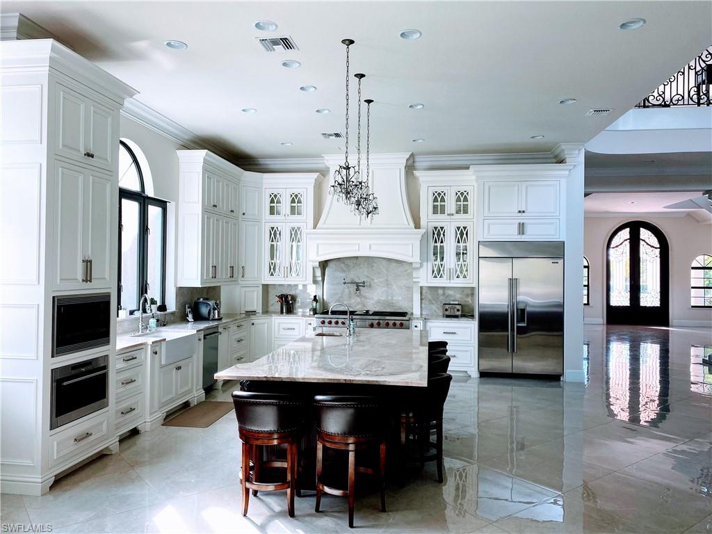 Undisclosed Address Naples, FL 34109 - Photo 14 of 33 a kitchen with stainless steel appliances granite countertop a stove and a refrigerator