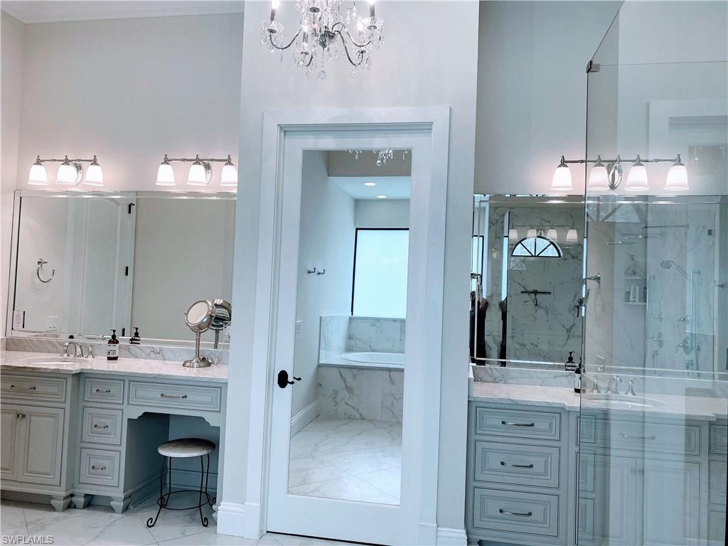 Undisclosed Address Naples, FL 34109 - Photo 16 of 33 a bathroom with a sink vanity and a mirror