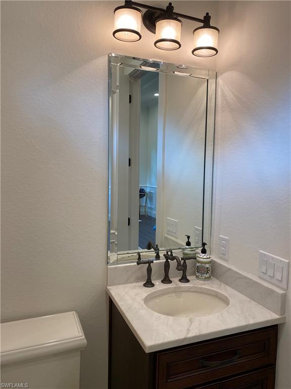 Undisclosed Address Naples, FL 34109 - Photo 20 of 33 a bathroom with a sink and a mirror