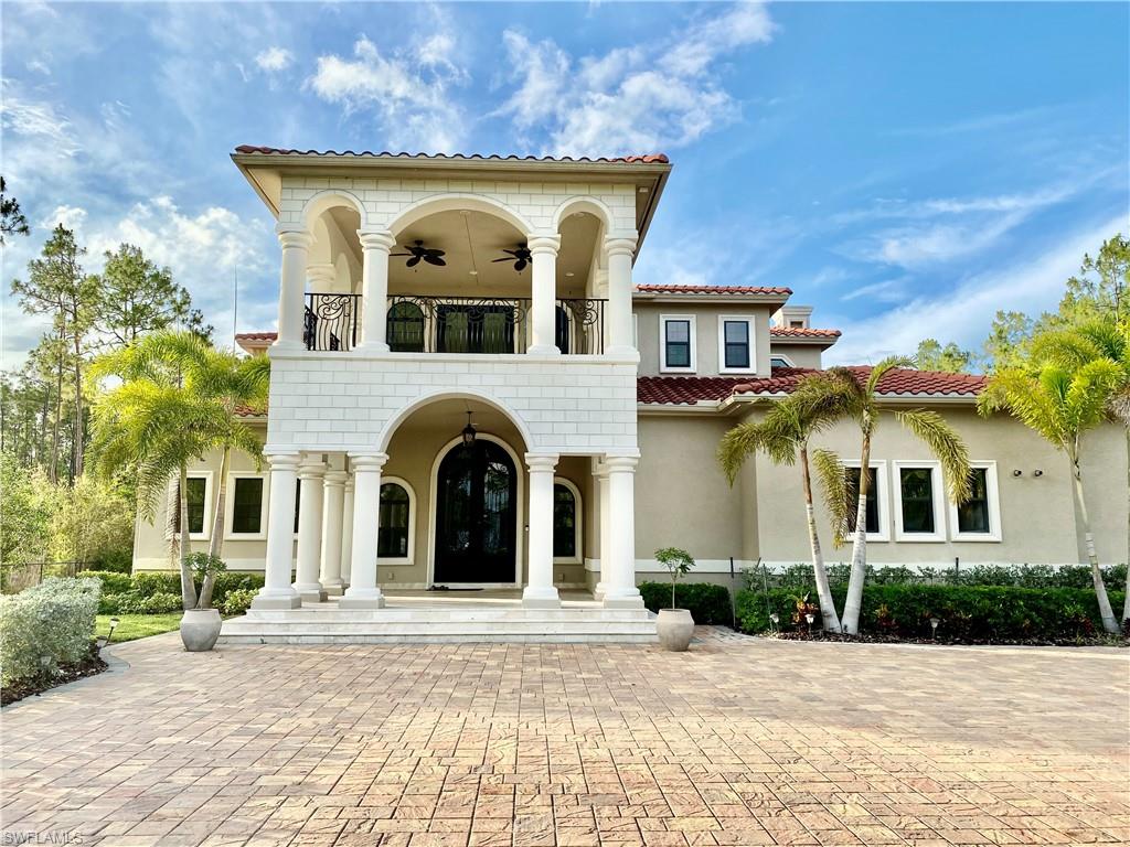 Undisclosed Address Naples, FL 34109 - Photo 3 of 33 a front view of a house with a yard