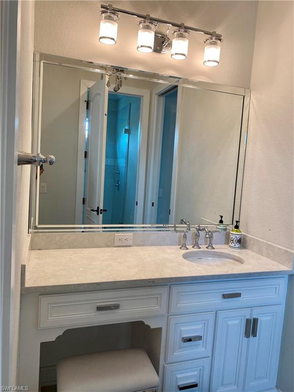 Undisclosed Address Naples, FL 34109 - Photo 27 of 33 a bathroom with a sink and a mirror