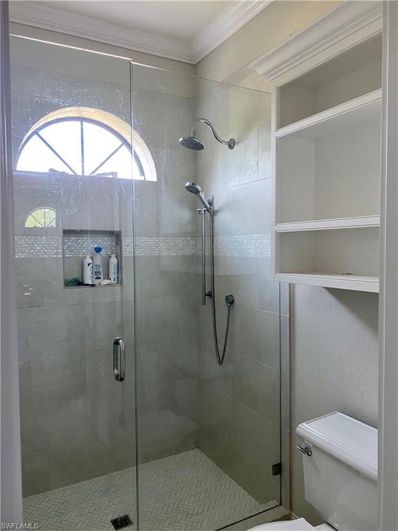 Undisclosed Address Naples, FL 34109 - Photo 29 of 33 a bathroom with a shower a toilet and a window