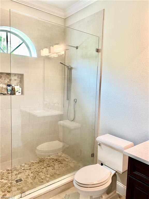 Undisclosed Address Naples, FL 34109 - Photo 31 of 33 a bathroom with a granite countertop bathtub shower sink mirror and toilet