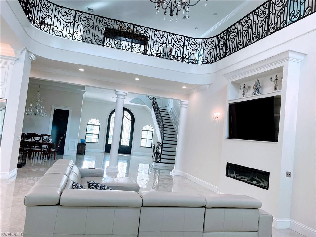 Undisclosed Address Naples, FL 34109 - Photo 10 of 33 a living room with furniture and a flat screen tv