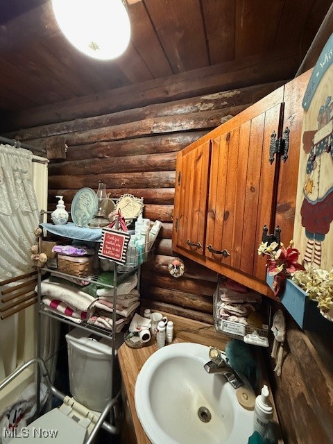 15639 Grove Road Southwest Port Washington, OH 43837 - Photo 24 of 31 Bathroom with rustic walls, vanity, and a shower with shower curtain