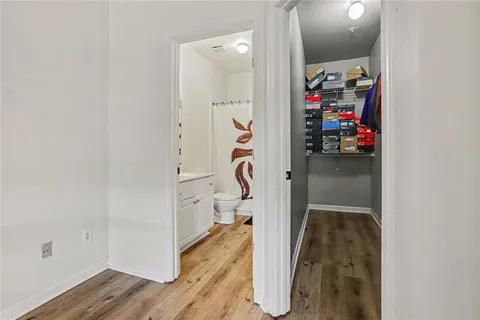 a bathroom with a shower sink vanity mirror and toilet