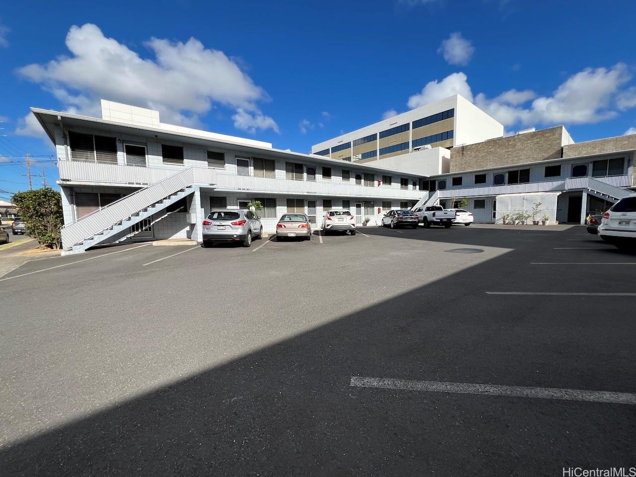 a view of a building with car parked