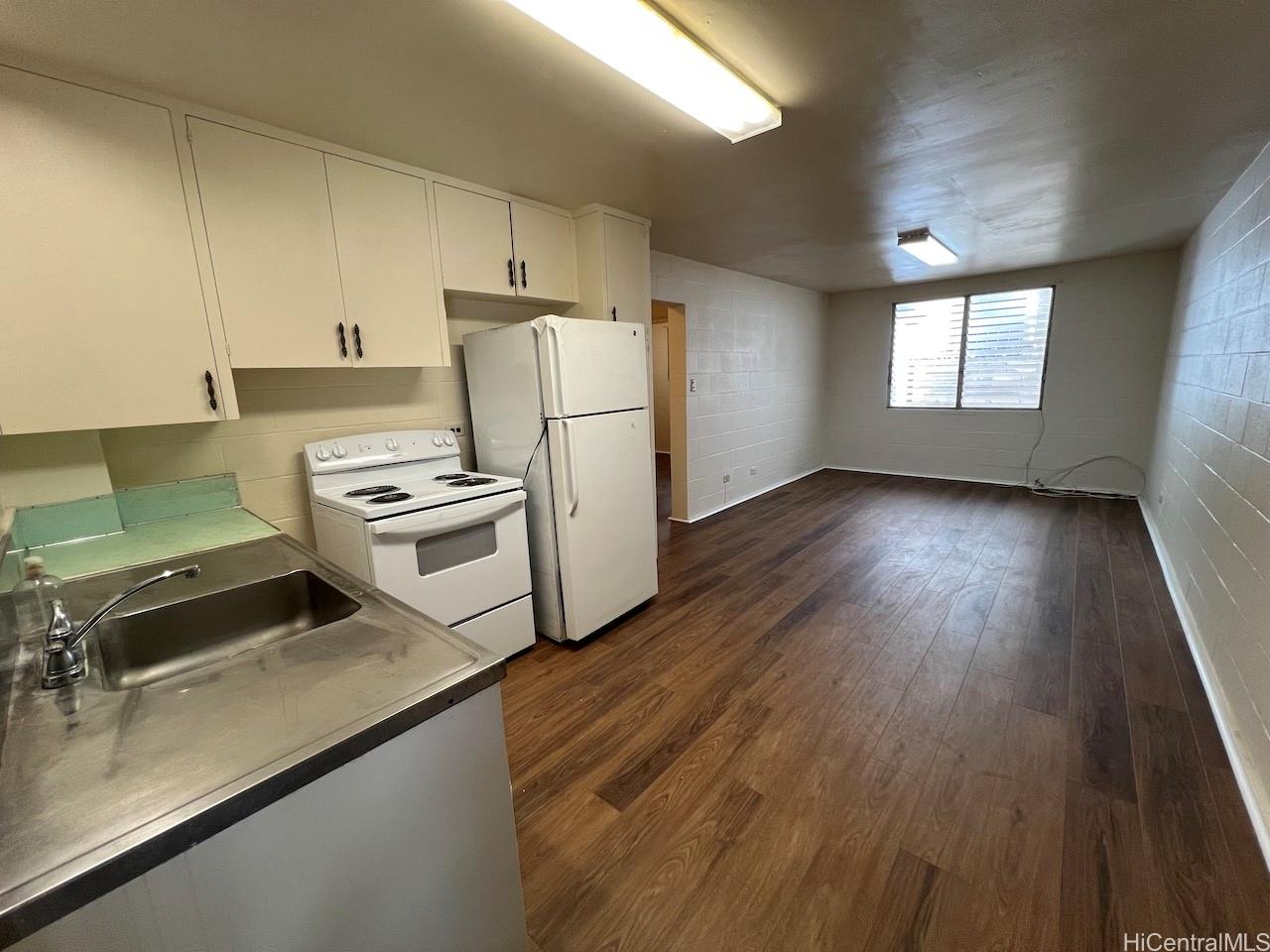 1920 Young Street, Unit 6 Honolulu, HI 96826 - Photo 2 of 8 a kitchen with a refrigerator and a stove top oven