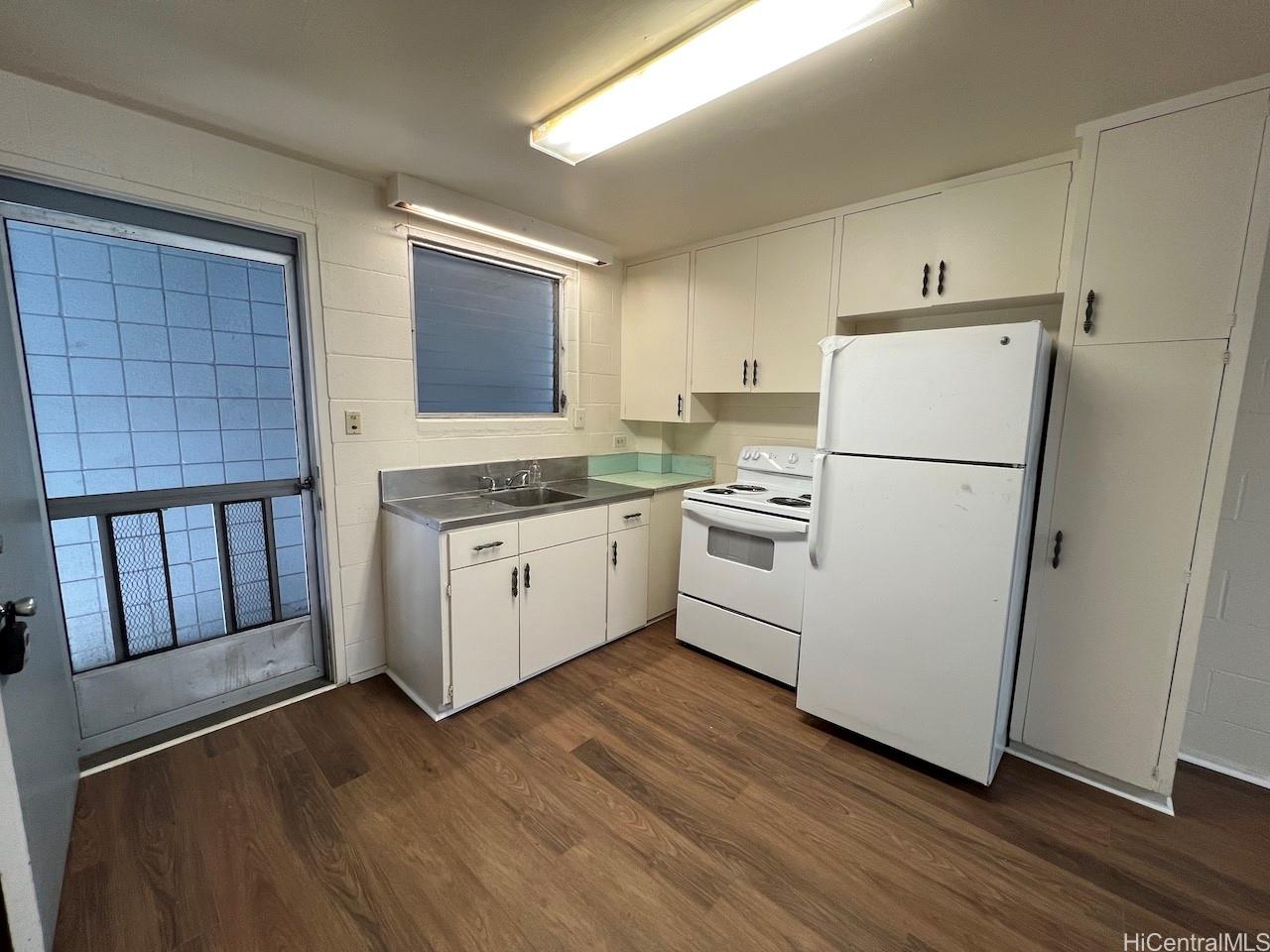 1920 Young Street, Unit 6 Honolulu, HI 96826 - Photo 3 of 8 a white refrigerator freezer sitting inside of a kitchen