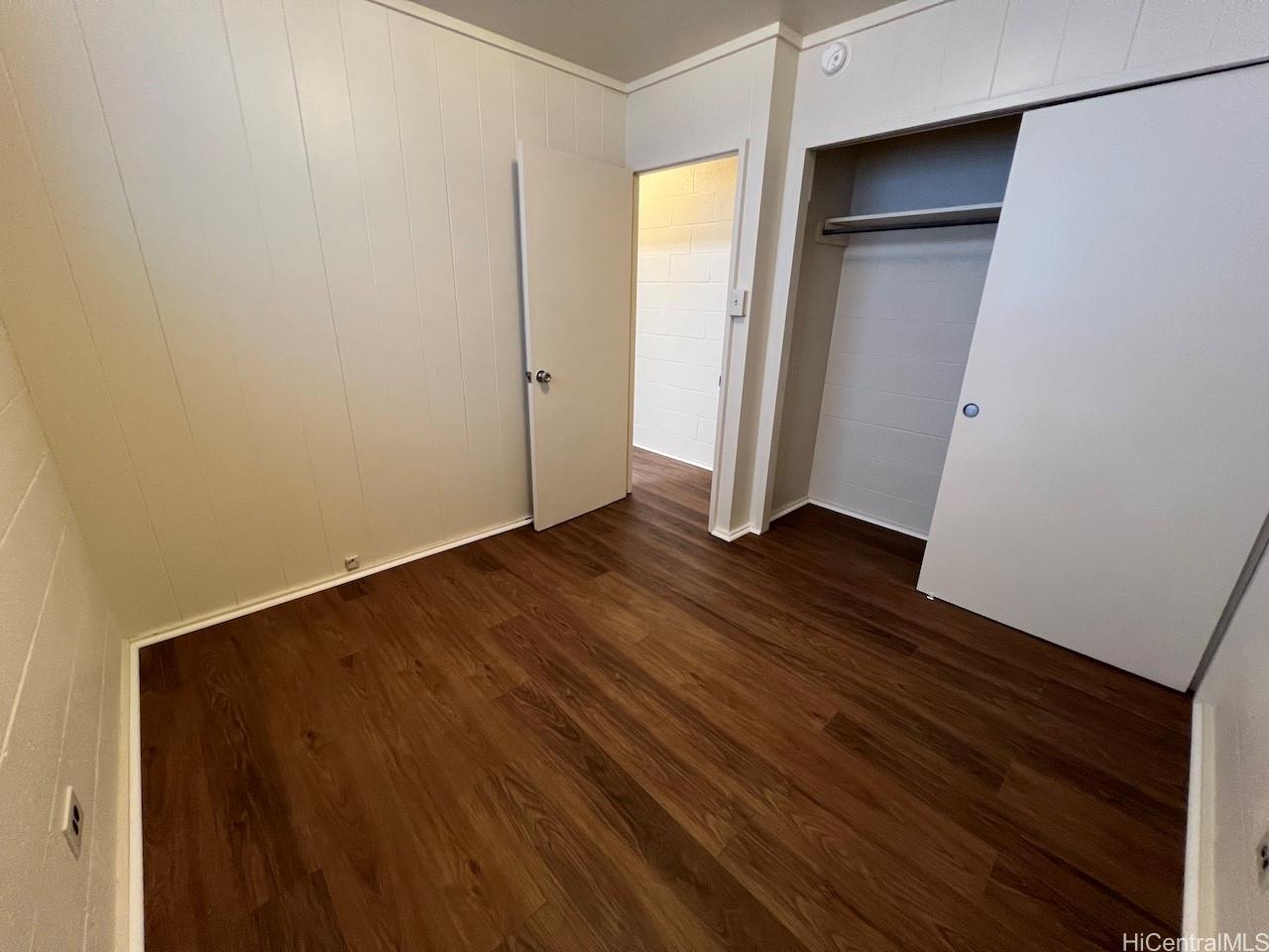 1920 Young Street, Unit 6 Honolulu, HI 96826 - Photo 5 of 8 a view of an empty room with wooden floor and closet
