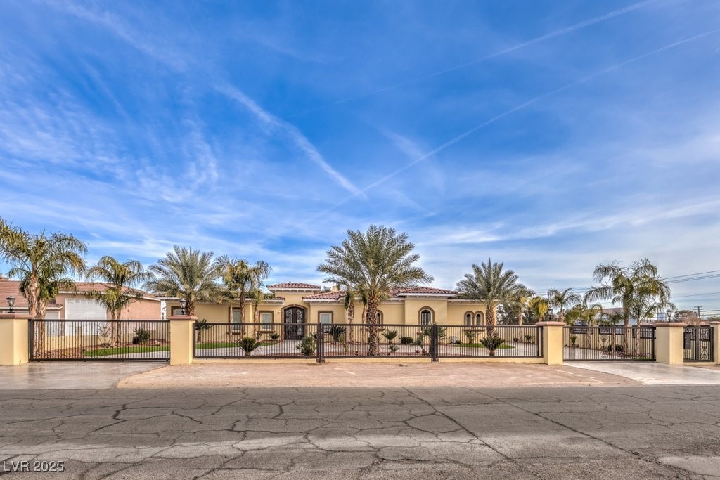 2780 El Camino Road Las Vegas, NV 89146 - Photo 19 of 90 Mediterranean / spanish-style house with a tile roof, a fenced front yard, a gate, and stucco siding