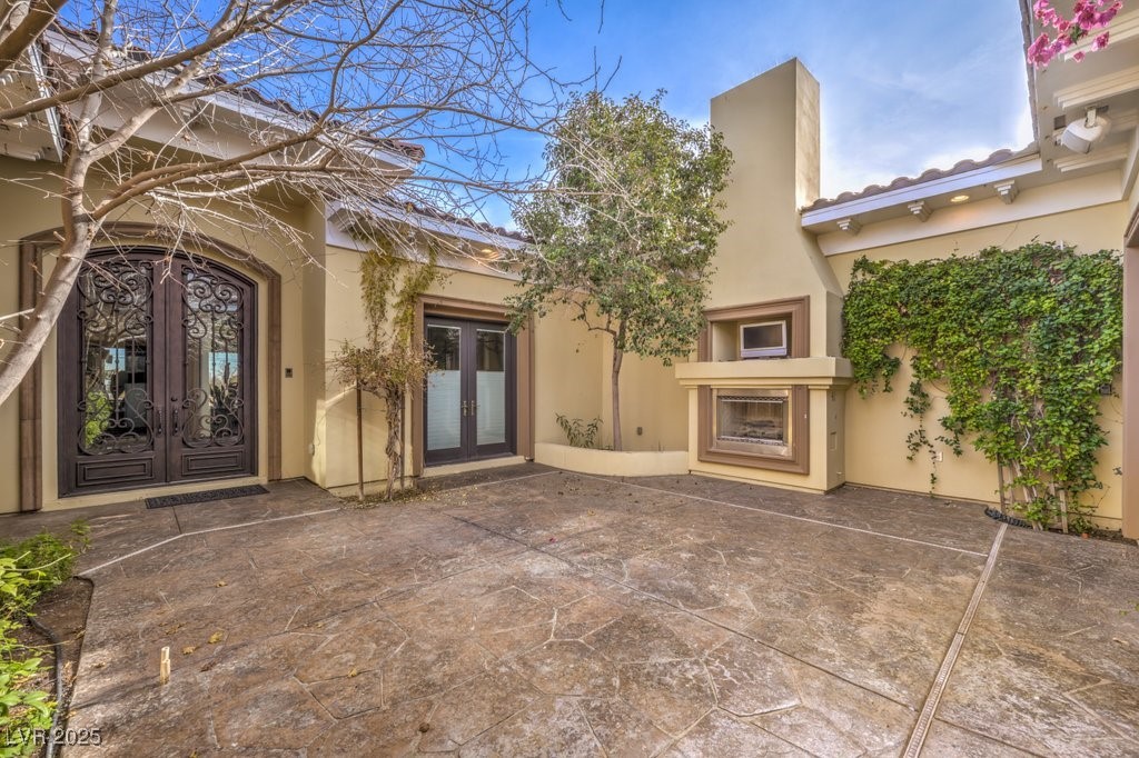 2780 El Camino Road Las Vegas, NV 89146 - Photo 25 of 90 Doorway to property featuring french doors, a patio, and stucco siding