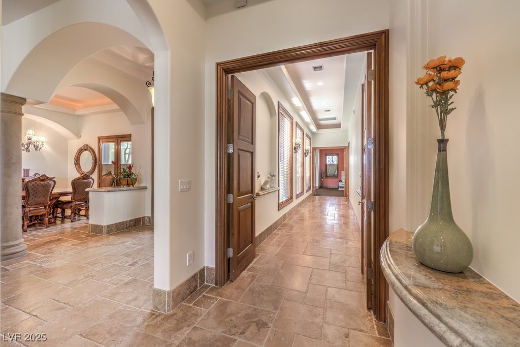2780 El Camino Road Las Vegas, NV 89146 - Photo 40 of 90 Hall featuring plenty of natural light, stone tile floors, a raised ceiling, and baseboards