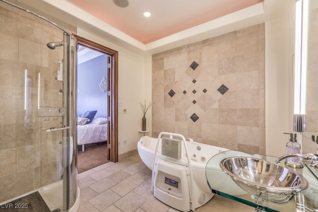 2780 El Camino Road Las Vegas, NV 89146 - Photo 49 of 90 Ensuite bathroom featuring ensuite bathroom, recessed lighting, tile patterned floors, a sink, and a stall shower