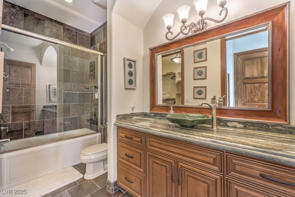 2780 El Camino Road Las Vegas, NV 89146 - Photo 51 of 90 Full bathroom featuring toilet, tile patterned floors, enclosed tub / shower combo, and vanity