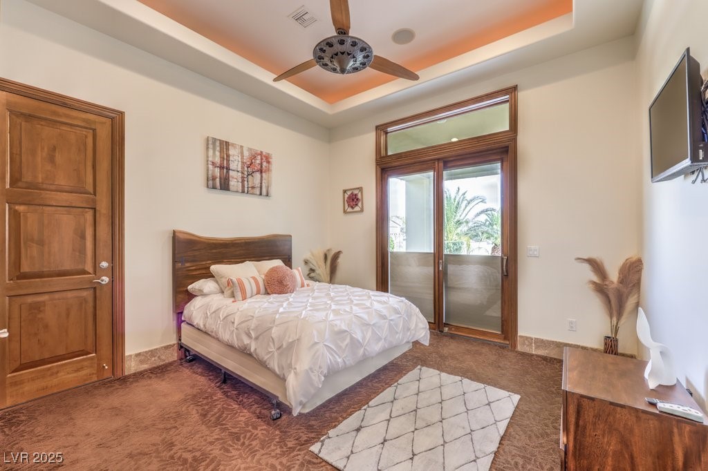 2780 El Camino Road Las Vegas, NV 89146 - Photo 58 of 90 Bedroom featuring carpet flooring, access to exterior, a ceiling fan, a tray ceiling, and visible vents