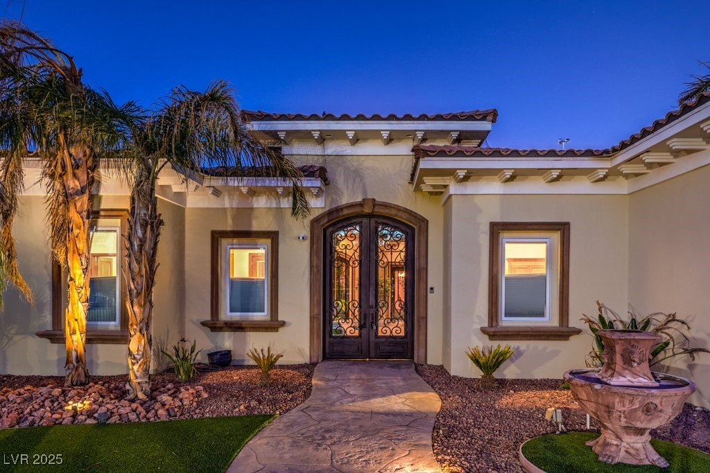 2780 El Camino Road Las Vegas, NV 89146 - Photo 6 of 90 Doorway to property featuring stucco siding, french doors, and a tile roof