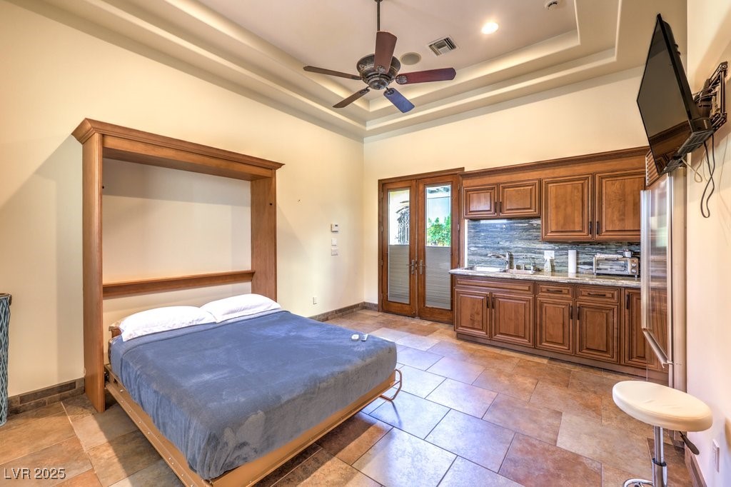 2780 El Camino Road Las Vegas, NV 89146 - Photo 70 of 90 Bedroom with french doors, visible vents, a raised ceiling, baseboards, and access to outside