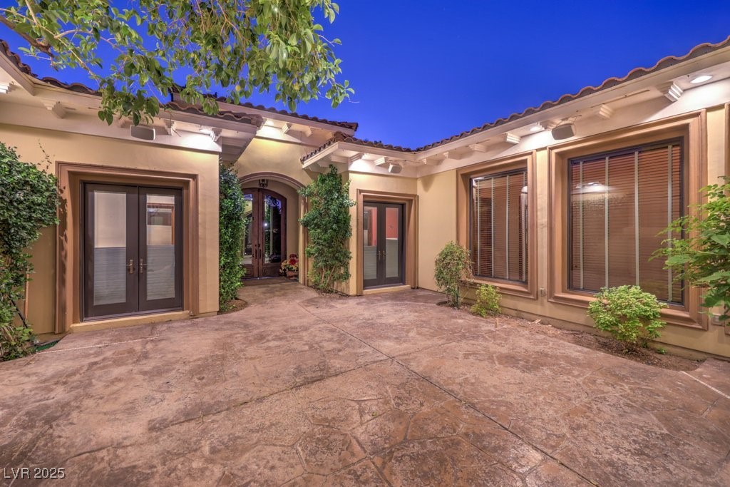 2780 El Camino Road Las Vegas, NV 89146 - Photo 8 of 90 View of exterior entry featuring french doors, stucco siding, and a patio area