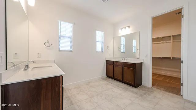 a spacious bathroom with a bathtub sink and mirror
